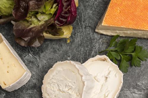 a table topped with cheese and other food items at Inselhotel König in Norderney