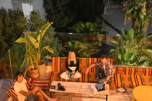 a group of people sitting on a couch at Playa Del Sol Surf House in Tamraght Ouzdar