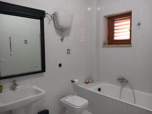 a bathroom with a sink and a toilet and a bath tub at Piumahouse B&B in Catanzaro