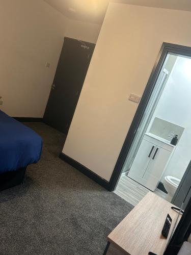 a bedroom with a sliding glass door and a bed at Tammys Lodge in Stoke on Trent