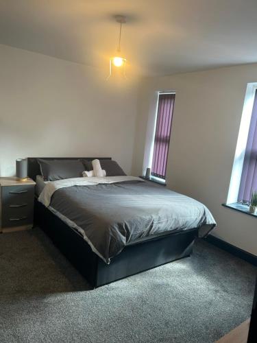 a bedroom with a bed and a window at Tammys Lodge in Stoke on Trent