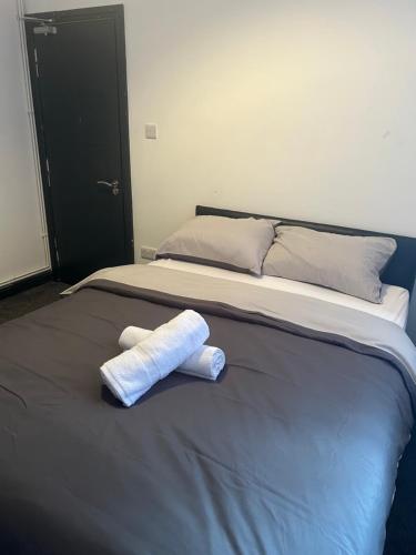 a bed with two towels on top of it at Tammys Lodge in Stoke on Trent