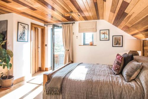 a bedroom with a large bed and a large window at Springhill Studio, Brimham Rocks Yorkshire Dales in Grantley