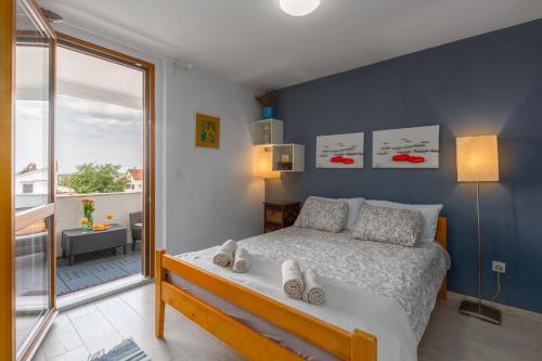 a bedroom with a bed with shoes on it at Apartment Blu in Poreč