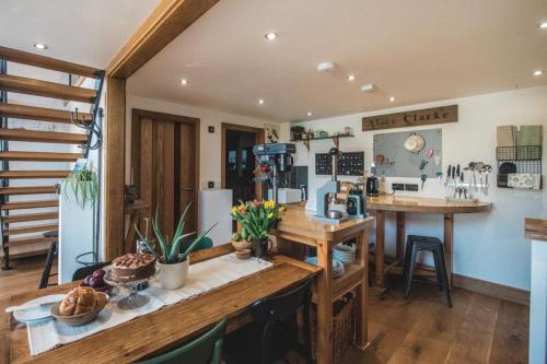 a kitchen with a wooden table and a counter at Springhill Studio, Brimham Rocks Yorkshire Dales in Grantley
