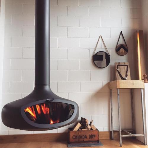 a fireplace in a white wall with a fire place at Springhill Studio, Brimham Rocks Yorkshire Dales in Grantley