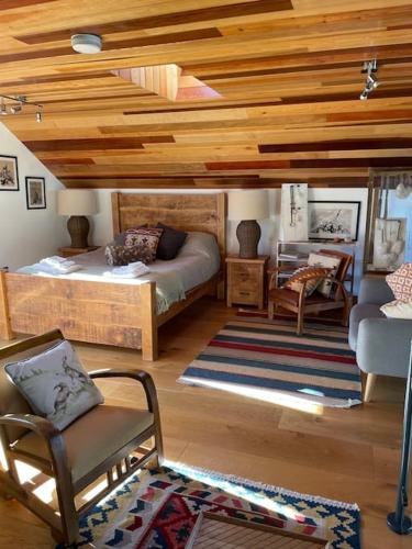 a bedroom with two beds and a chair and a couch at Springhill Studio, Brimham Rocks Yorkshire Dales in Grantley
