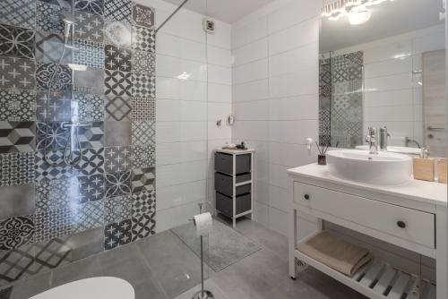 a bathroom with a sink and a shower at Apartment Blu in Poreč