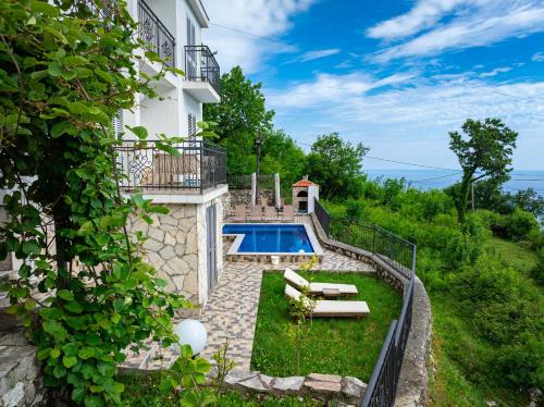 a villa with a swimming pool and a house at Villa Tranquila in Budva