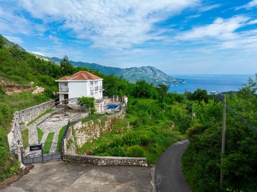 a house on the side of a hill with a road at Villa Tranquila in Budva