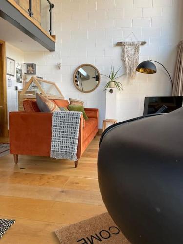 a living room with a couch and a mirror at Springhill Studio, Brimham Rocks Yorkshire Dales in Grantley