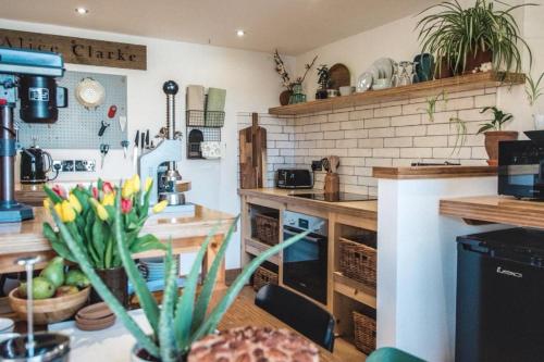 a kitchen with a vase of flowers on a table at Springhill Studio, Brimham Rocks Yorkshire Dales in Grantley