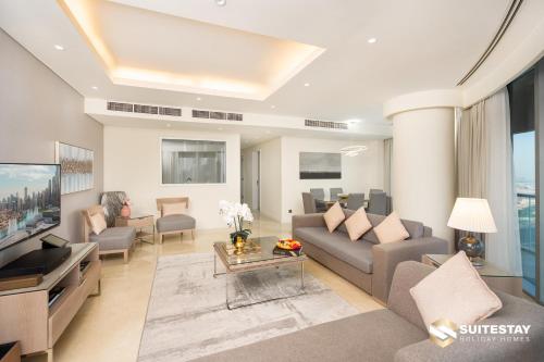 a living room with a couch and a tv at OSTAY -Address Dubai Mall - The Residence in Dubai