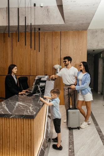 a group of people standing around an office counter at Rest&Ski Spa Resort in Bukovel