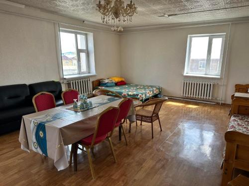 - un salon avec une table, des chaises et un canapé dans l'établissement Selenge, à Mörön