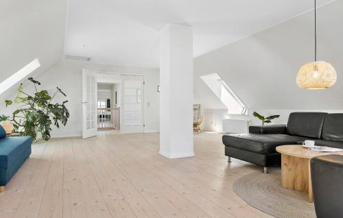 a living room with a couch and a table at 6 Bedroom Stunning Home In Højer in Højer