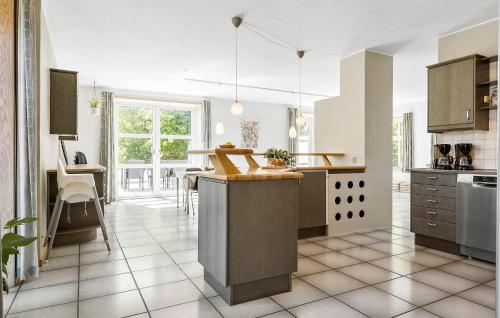 a kitchen with a island in the middle at 6 Bedroom Stunning Home In Højer in Højer