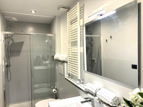 a bathroom with a shower and a sink and a mirror at CINQUE TERRE MONEGLIA in Moneglia