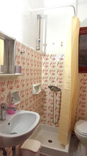 a bathroom with a sink and a toilet at Apartments Papadioti in Pefki