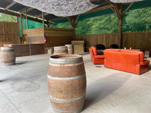 a room with a bunch of furniture and a barrel at Grand gîte de caractère à la campagne in Fercé