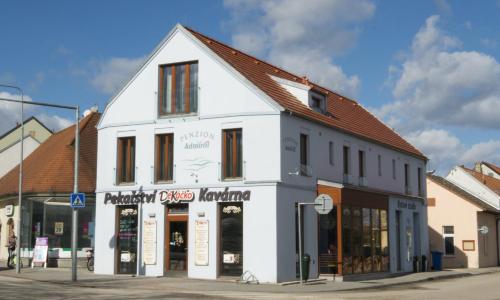 a white building on the corner of a street at Penzion Admirál in Třeboň