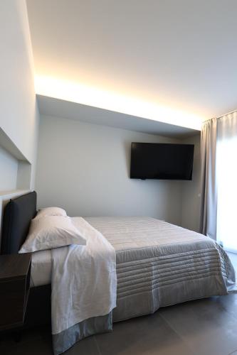 a bedroom with a bed and a flat screen tv at Casa Tua in Formigine