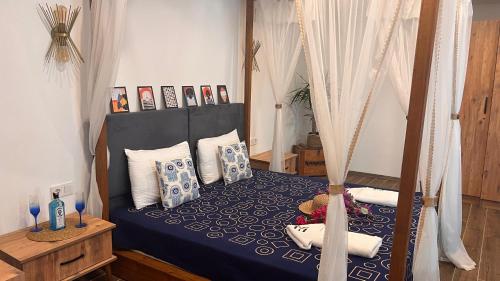 a bedroom with a canopy bed with pillows at Elin Otel Alaçatı in Cesme
