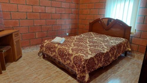 a bedroom with a bed with a book on it at Lavanda Beach House in Sevan