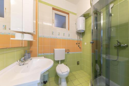 a bathroom with a sink and a toilet and a shower at Lions Suites in Split