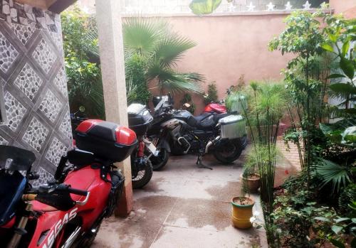 a group of motorcycles parked in a garage at Hôtel Villa des étoiles in Ourika