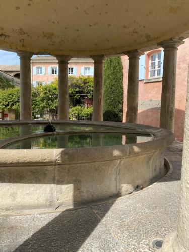a fountain in the courtyard of a building at La tour de Grignan in Grignan
