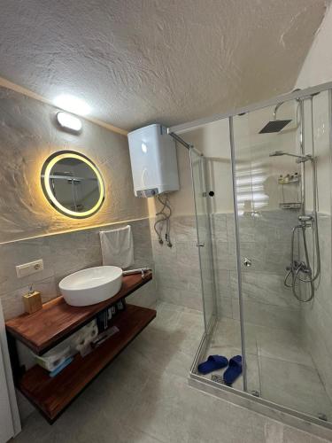 Mardin Merkezde Deluxe Room في ماردين: حمام مع حوض ودش زجاجي