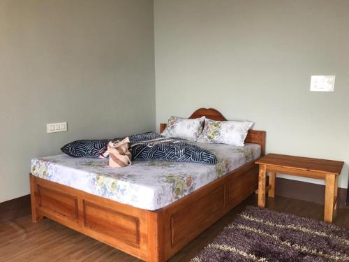 a bed with a cat sitting on top of it at Khee Homestay in Kurseong