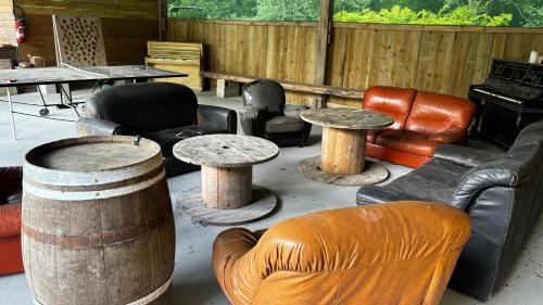 a room filled with furniture and tables and chairs at Grand gîte de caractère à la campagne in Fercé