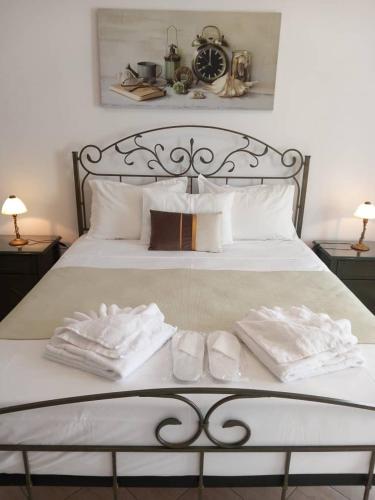 a white bed with two towels on top of it at Venikouas Hotel in Platis Yialos Sifnos