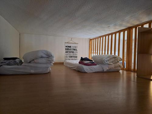 two bean bags sitting in a room with a wooden floor at Appartement de montagne in La Mure