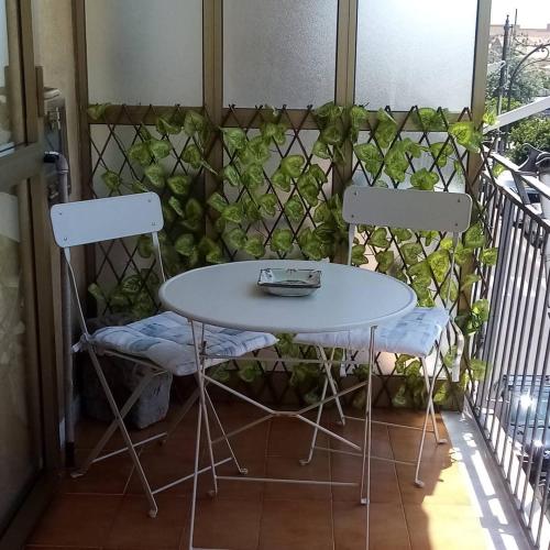 a table and two chairs on a balcony at Leucosia Bed & Breakfast in Salerno