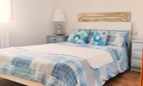 ein Schlafzimmer mit einem Bett mit einer blauen und weißen Decke in der Unterkunft Appartement Rosa (Albox) in Albox