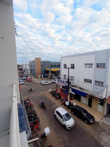 uma vista para um parque de estacionamento com carros e motos em Apartamento Mobiliado no Centro Comercial em Imperatriz
