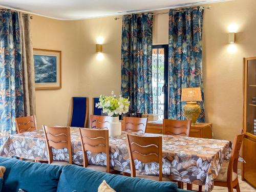 a dining room with a table and chairs and a blue couch at Casa Canavial in Lagos