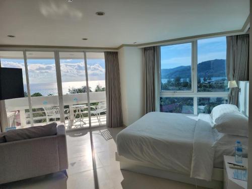 a bedroom with a bed and a view of a balcony at Andaman sea view private in Patong Beach
