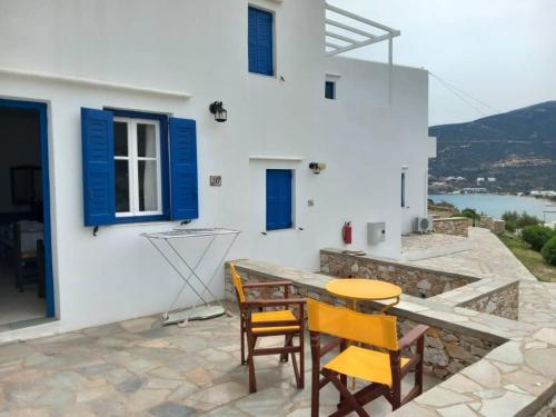 a patio with a table and chairs and a building at Venikouas Hotel in Platis Yialos Sifnos