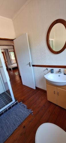 a bathroom with a sink and a mirror at Serenity, Ponta do Ouro in Ponta do Ouro