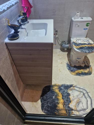 a bathroom with a sink and a toilet at Beachfront Gorgeous Flat in Tangier in Tangier