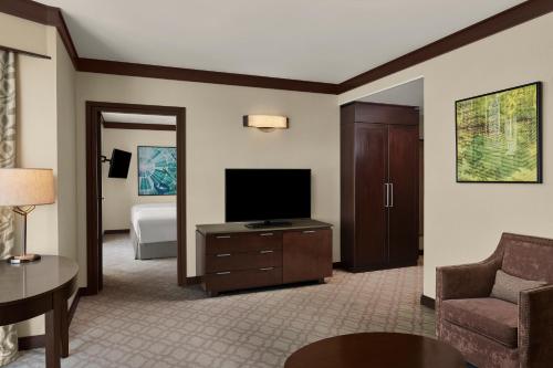 a living room with a couch and a television at Doubletree By Hilton Jabal Omar Makkah in Makkah