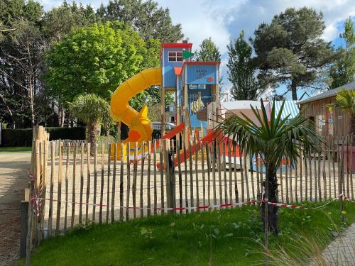 a playground with a slide in a park at Lebraz 2 in Saint-Lunaire