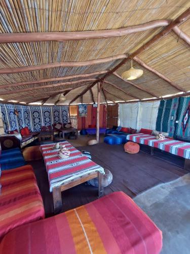 a large room with colorful tables and couches in it at LA GRANJA in Tetouan