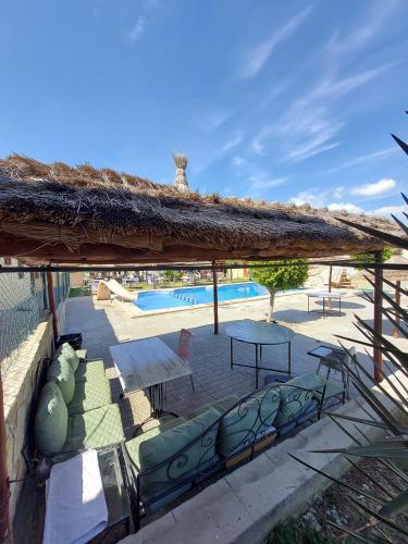 a pavilion with a table and chairs and a pool at LA GRANJA in Tetouan