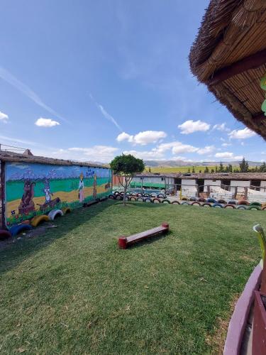 a mural on the side of a building with a grass field at LA GRANJA in Tetouan