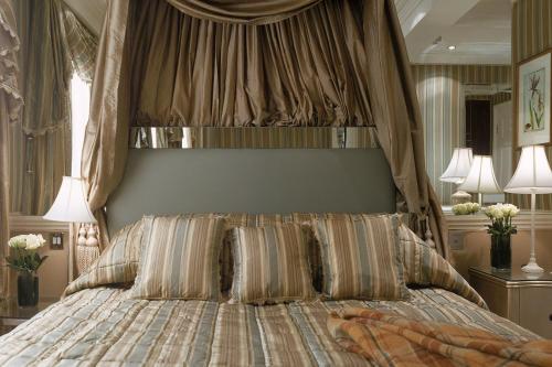 a bedroom with a large bed with a canopy at The Montague On The Gardens in London